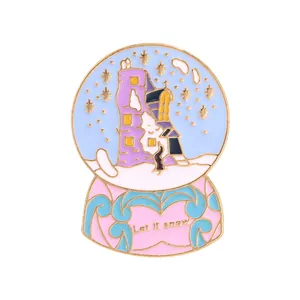 Detail of enamel snow globe pin featuring a castle with Let It Snow engraving