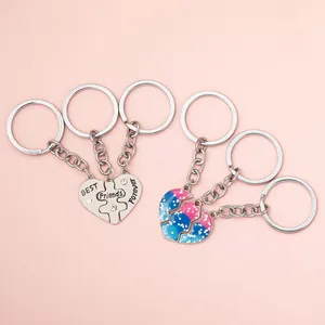 Three-piece heart puzzle keychain set with crystal accents and pink blue enamel finish