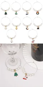 Close-up of Christmas wine glass charms featuring white pearls and festive alloy pendants