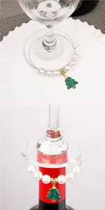 Detail of Christmas tree wine glass charm with green enamel and pearl on glass stem