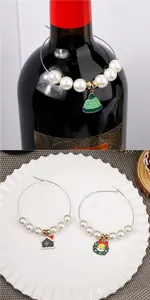 Detail of Christmas wine glass charms with gingerbread and wreath pendants on pearls