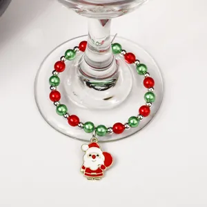Detail view of Santa Claus charm with red and green beads on a wine glass stem