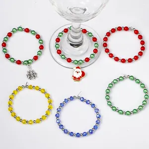 Detail view of 6-piece beaded Christmas wine glass charms around a glass base
