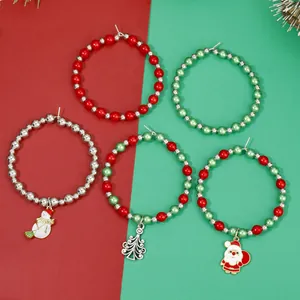 Detail of Christmas wine glass charms with beads, snowman and Santa pendants