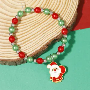Detail of Christmas wine glass ring with red green beads and Santa Claus pendant