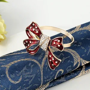 Golden napkin ring with red enamel bowknot and sparkling crystal rhinestones for weddings