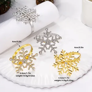 Close-up of snowflake napkin rings showing dimensions 4.4cm diameter in gold and silver