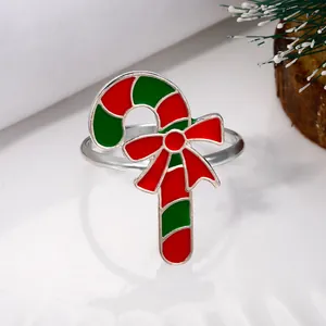 Detailed view of candy cane napkin ring with red bow on festive white texture