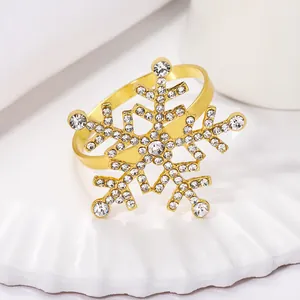 Close-up of golden snowflake napkin ring with sparkling white rhinestones on plate