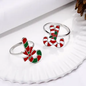 Detail of candy cane napkin rings with enamel finish on a white festive plate