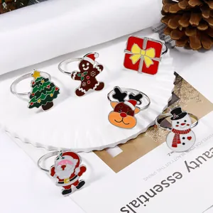 Detail of metal Christmas napkin rings with colorful enamel holiday icons for table decor