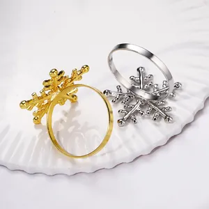 Detailed view of gold and silver snowflake napkin rings with polished metallic finish