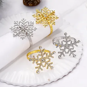 Set of four snowflake napkin rings in gold and silver with rhinestones and metal hollow-out