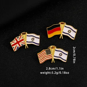 Detailed macro of crossed flags enamel pins with gold metal trim and 2.8x2cm dimensions
