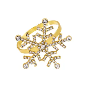 Macro shot of gold snowflake napkin ring with sparkling crystals for holiday table decor