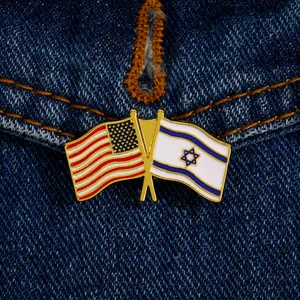 Detail of USA and Israel flags enamel pin with gold plating on denim fabric texture