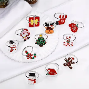 Set of 12 Christmas napkin rings featuring Santa, Reindeer and Tree on white silk base