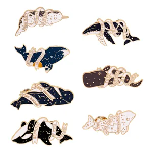 Set of seven marine animal enamel pins featuring whales with motivational quote ribbons