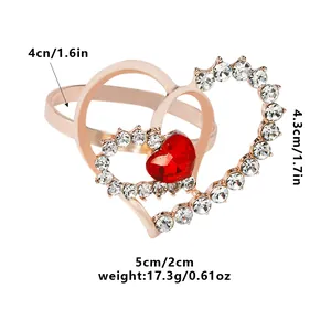 Close-up of rose gold heart napkin ring with clear crystals and a red heart gemstone