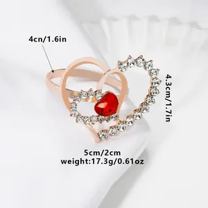 Close-up of double heart alloy napkin ring with sparkling rhinestones and red gem