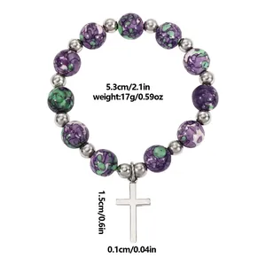 Natural stone beaded bracelet with purple and green textures and silver cross pendant