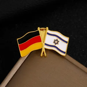 Detail of metal lapel pin featuring crossed German and Israeli flags with gold finish
