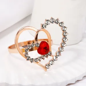 Golden double heart napkin ring with sparkling rhinestones and a red heart gemstone