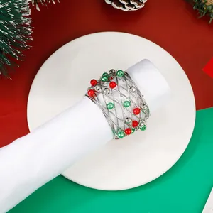 Detailed view of Christmas bell napkin ring with festive red, green, and silver beads