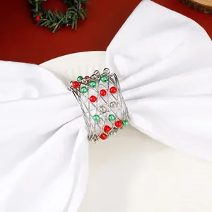 Detail of Christmas bell napkin ring with red, green and silver beads on metal spiral