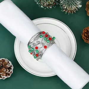 Close-up of silver wire Christmas bell napkin ring with red and green festive beads