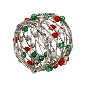 Christmas napkin ring with red and green beads in a silver wire woven cage design