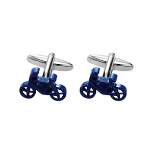 Macro detail of blue enamel bicycle cufflinks with polished silver-tone metal finish
