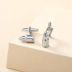 Polished silver bullet-shaped cufflinks for men's French shirts on a minimalist base