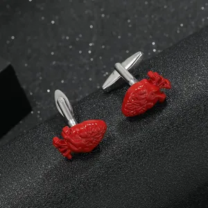 Polished silver men's shirt cufflinks with realistic red anatomical heart design