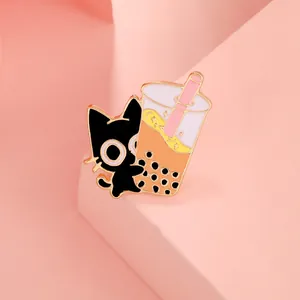 Detailed view of enamel cat pin with milk tea design and polished gold metal edges