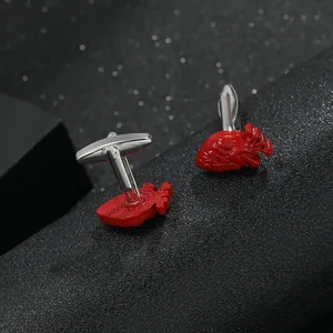 Macro shot of anatomical heart cufflinks with red enamel finish and silver metal base