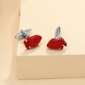 Macro shot of red anatomical heart cufflinks with polished silver stems on a display stand