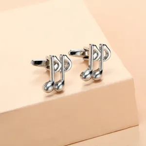Macro shot of polished silver music note cufflinks for French shirts with bullet back