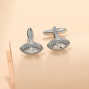 Detailed macro shot of silver zircon cufflinks with marquise-cut crystal in business style