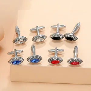 Mens silver cufflinks set with marquise stones in white black blue and red on display
