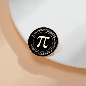 Macro shot of a black enamel Pi pin badge with gold-plated mathematical symbol and digits