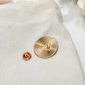 Golden Pi mathematical symbol pin badge back view with butterfly clasp and sunburst texture