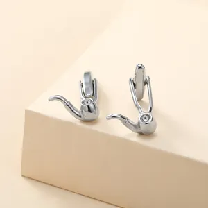 Detailed view of silver pipe shaped cufflinks with a polished metallic finish and inlay