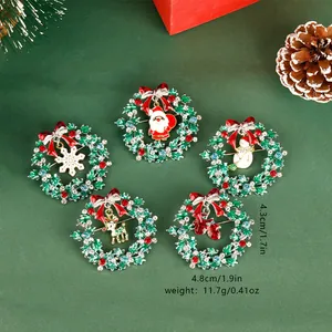 Detail view of five Christmas wreath brooches with colorful enamel and sparkling rhinestones