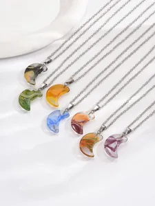 Detail of seven colorful crescent moon resin pendants with metallic silver cross chains