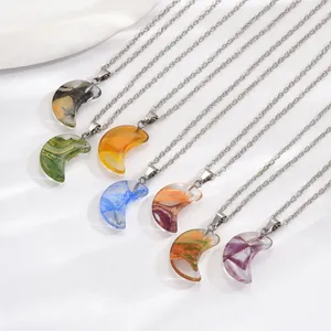 Macro detail of seven colorful crescent moon necklaces with silver-tone metal chains