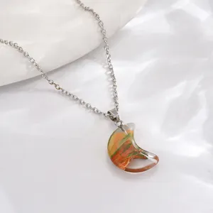 Detailed shot of crescent pendant with resin inlay on silver chain necklace