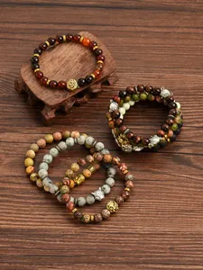 Detailed macro view of 8mm agate and tiger eye stone bracelets with lion head alloy charms