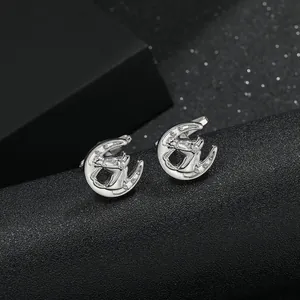 Detailed close-up of silver horse and horseshoe cufflinks with sparkling zircon stones