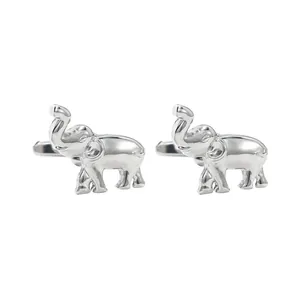 Detailed close-up of a pair of high-gloss silver elephant cufflinks with intricate texture